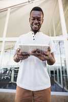 Smiling businessman using tablet computer