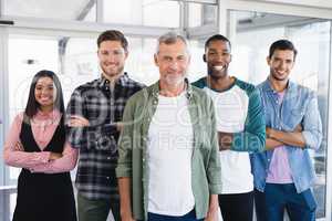 Portrait of smiling business people with arms crossed