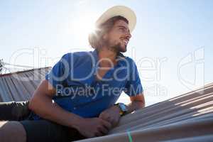 Smiling young man relaxing on hammock at beach