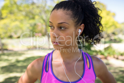 Jogger woman listening to headphones in the park