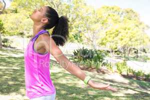 Female jogger stretching her arms