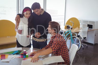 Young business colleagues discussing at office