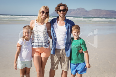 Portrait of happy family standing together at beach