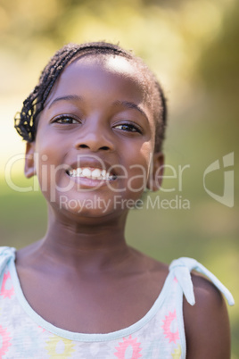 Portrait of smiling girl standing in forest