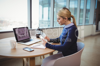 Executive using digital tablet at table