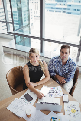 Overhead view of executives using laptop at desk