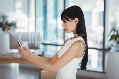 Female executive using mobile phone