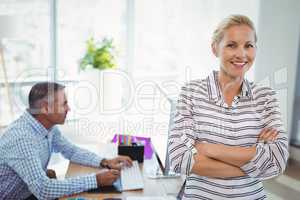 Portrait of smiling graphic designer standing with arms crossed
