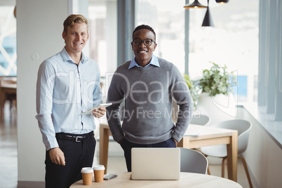 Smiling executives standing in office