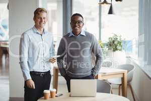 Smiling executives standing in office