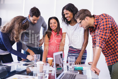 Happy business people discussing in office