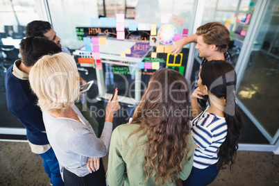 High angle view of business people discussing on glass wall