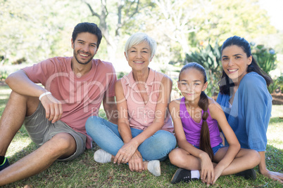 Happy family sitting in the park