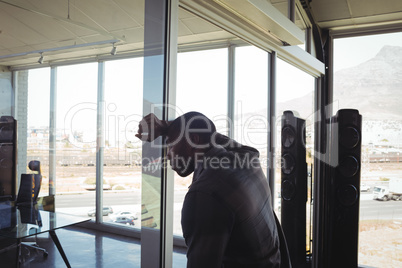 Tired businessman leaning on glass