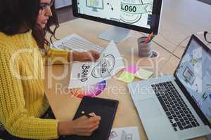 Young graphic designer working at office desk