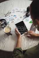 Businesswoman using digital tablet at creative office desk