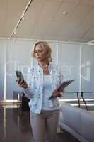 Businesswoman using mobile phone in office