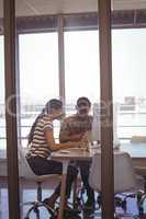 Businessman working with female colleague in office