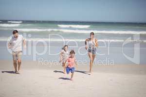 Happy family running at beach