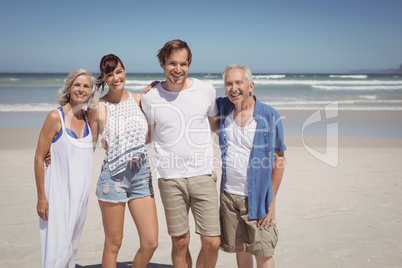 Portrait of happy family standing side by side at beach