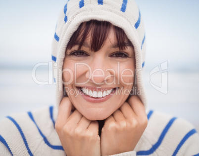 Close up portrait of smiling woman wearing hooded sweater