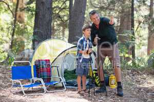 Father showing something to son in forest