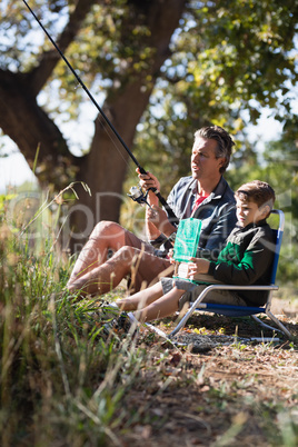 Father and son fishing in forest