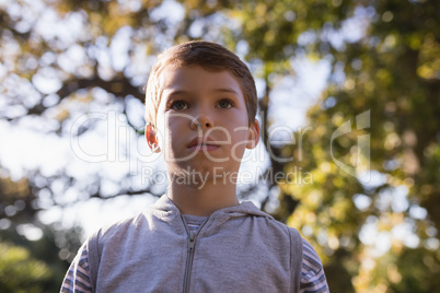 Low angle view of boy against trees