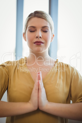 Executive meditating in office