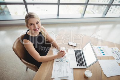 Overhead view of executive working at desk