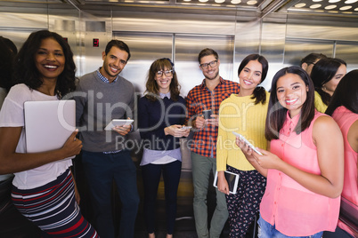 Portrait of business people standing in elevator