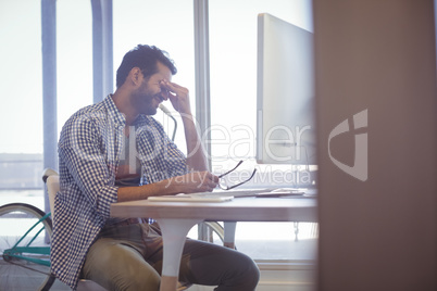 Depressed businessman sitting at desk
