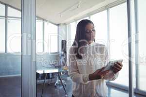 Young businesswoman using digital tablet in office