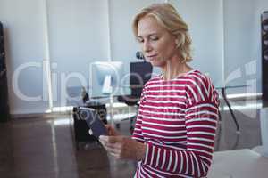 Businesswoman using mobile phone at office