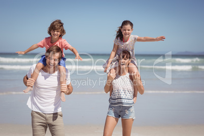 Portrait of cheerful family standing at beach