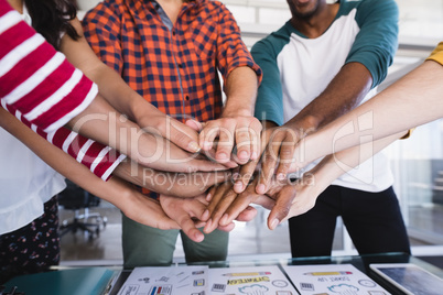 Close up of business people stacking hands