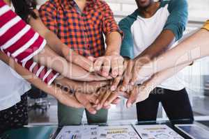 Close up of business people stacking hands