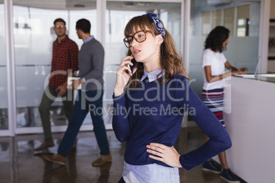 Businesswoman talking on phone in office