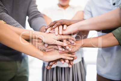 Close up of colleagues stacking hands