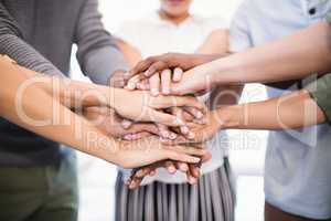 Close up of colleagues stacking hands