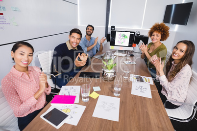 Portrait of colleagues clapping after presentation at creative office