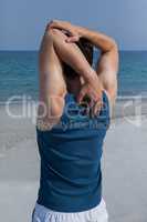 Man doing warm up on beach