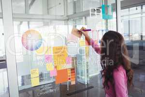 Designer making strategy on glass in creative office