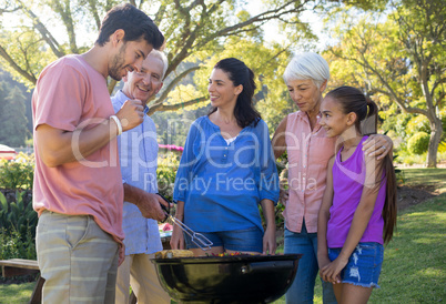 Family preparing barbecue in the park