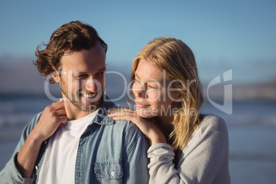 Young couple standing at beach