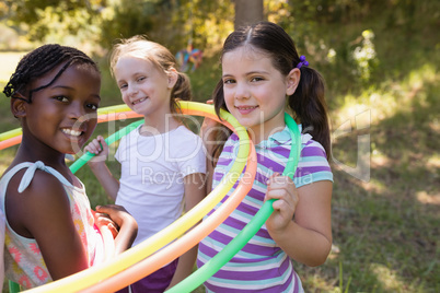 Girls wearing hula hoops around neck at campsite