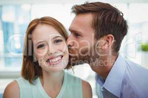 Affectionate man kissing woman