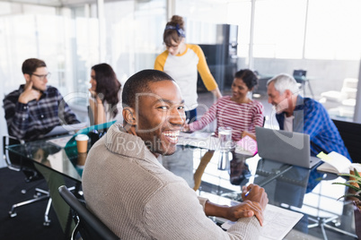 Smiling businessman sitting in meeting