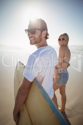 Happy young couple holding hands at beach