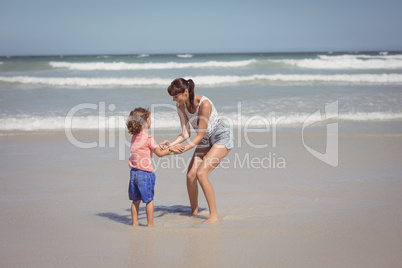 Happy son enjoying with mother on shore at beach